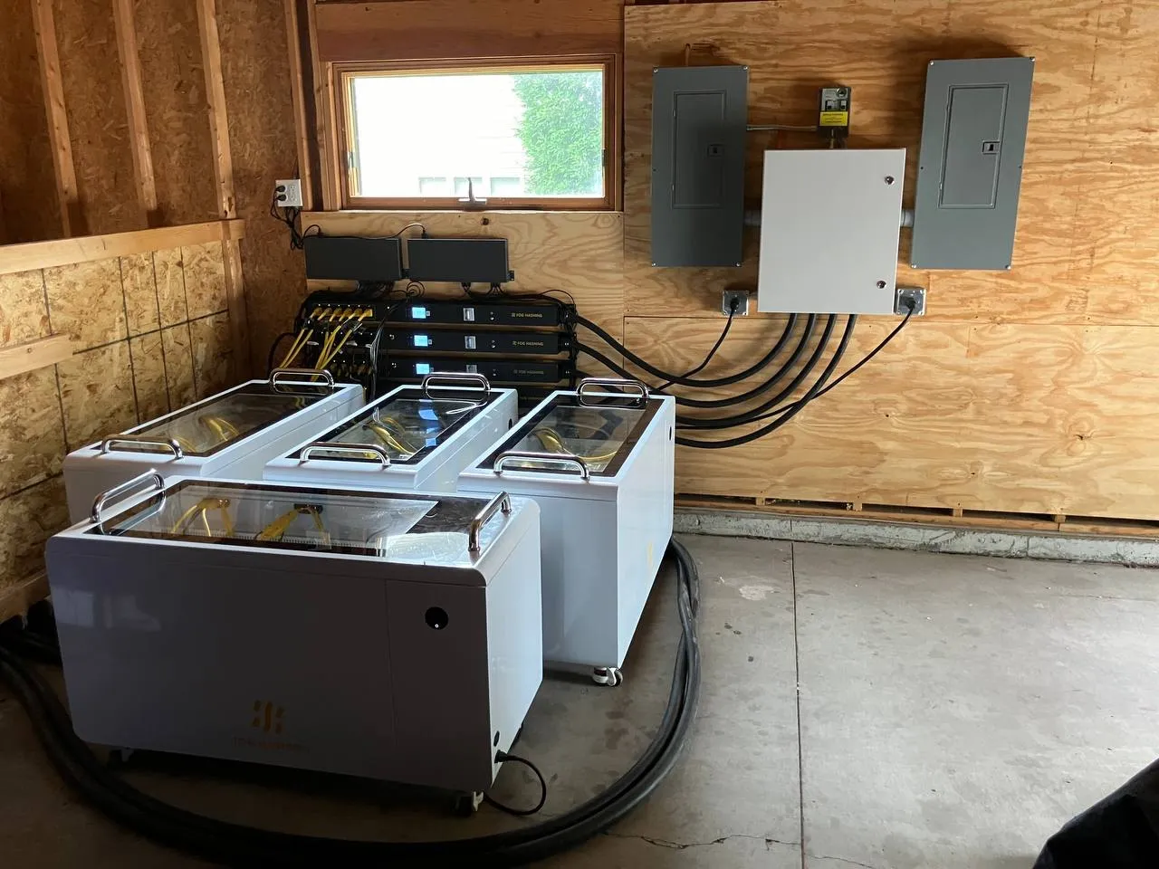 Three C Series tanks in a timber outbuilding, breaker panel on the wall behind
