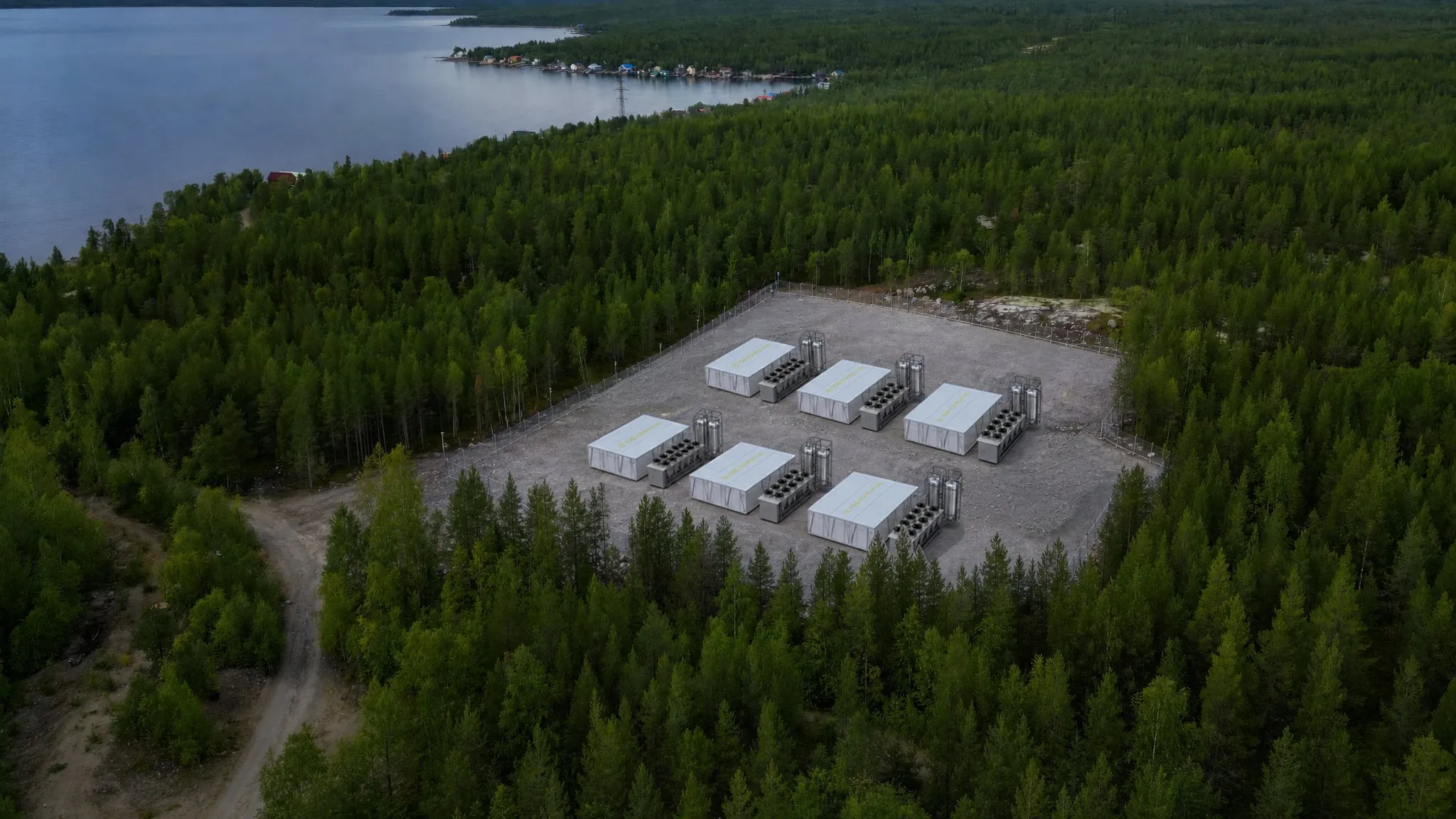 Rendering of a FogPod site: eight pods on a graded pad, each with its heat rejection skid alongside
