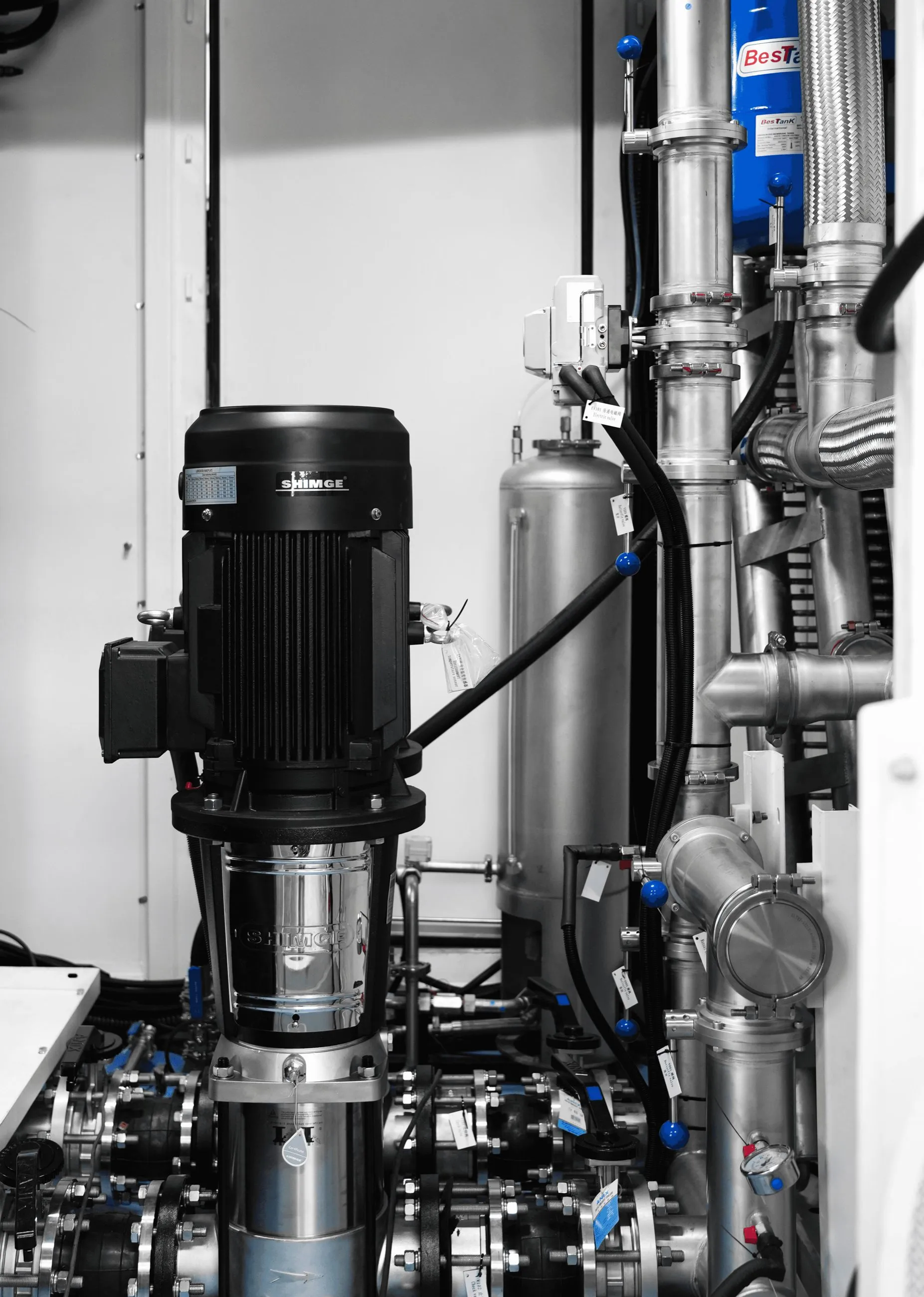 Inside the CDU: circulation pump and stainless distribution piping