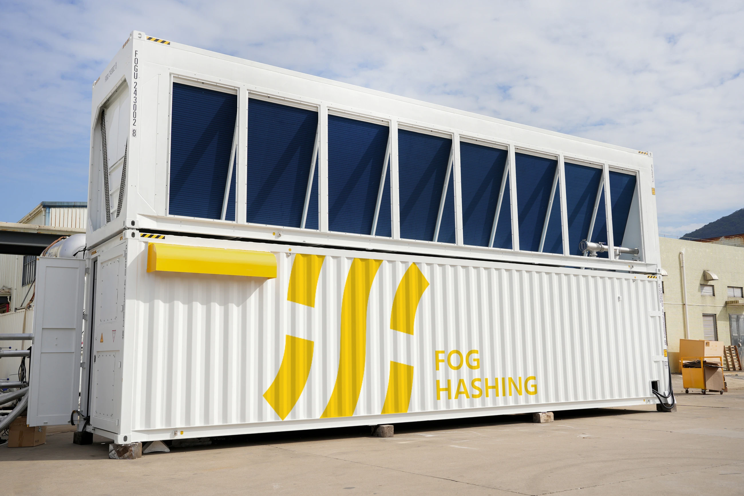 An HC40 container in the yard, radiator bank on the upper deck over the Fog Hashing wordmark