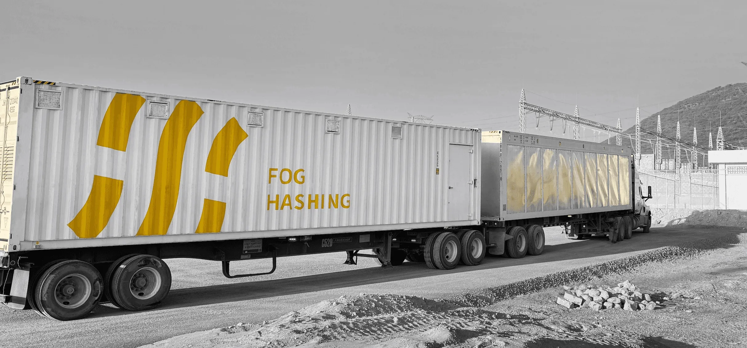 Two Fog Hashing containers on flatbed trailers arriving at a substation site