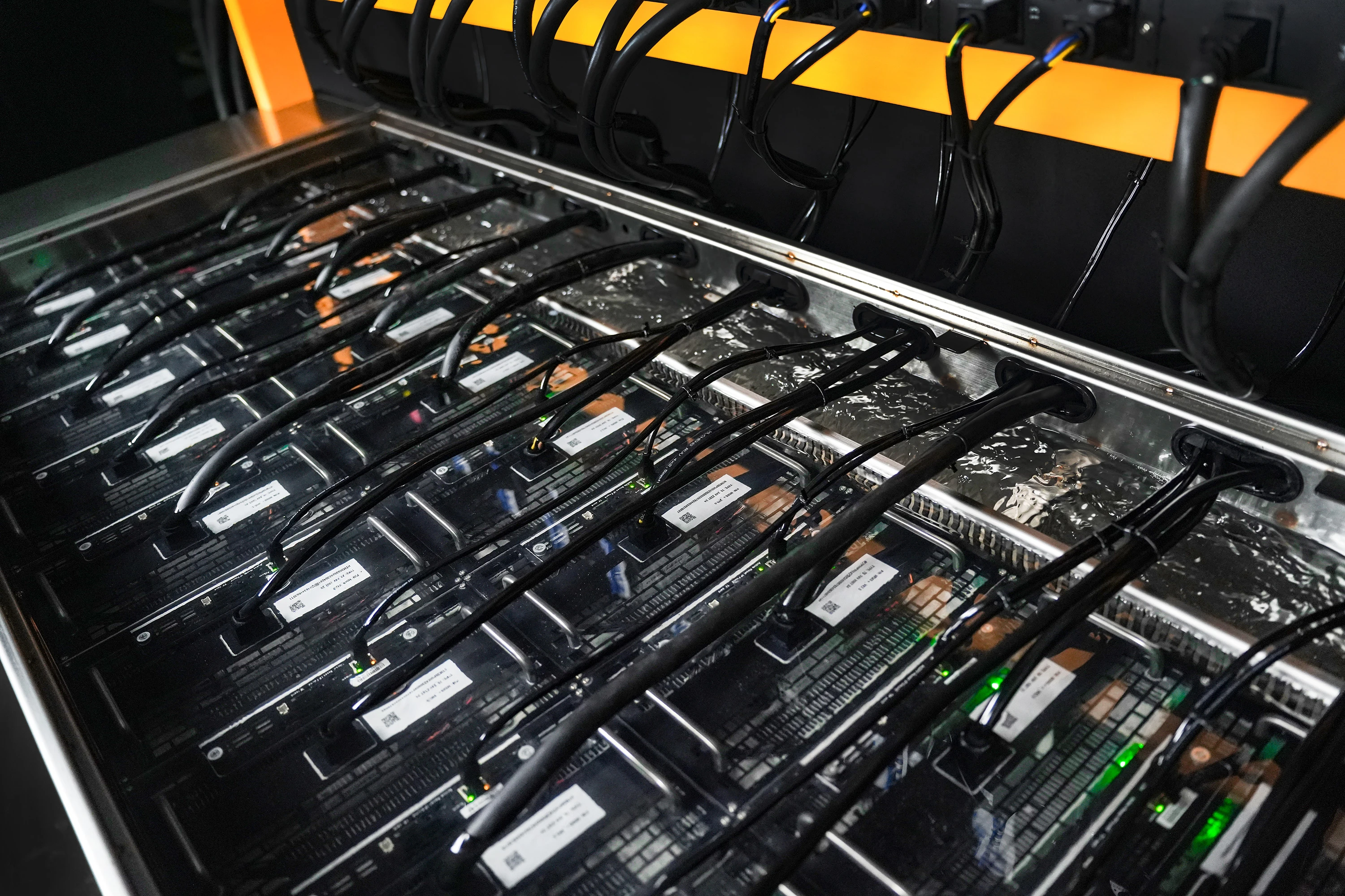 Miners running submerged in dielectric fluid inside a Fog Hashing B Series immersion tank