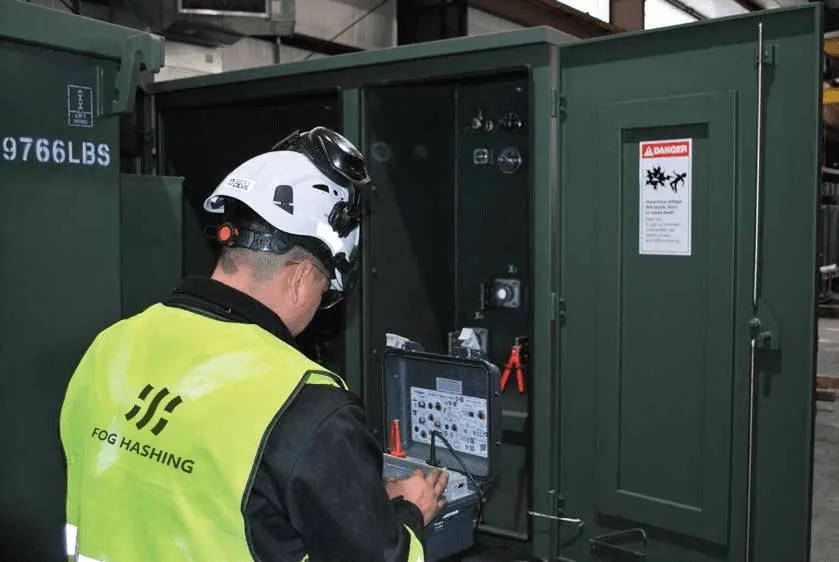 A Fog engineer working at an open pad-mount transformer